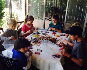 Six Inland Leaders Charter School students helping sort and removed paper from crayons.